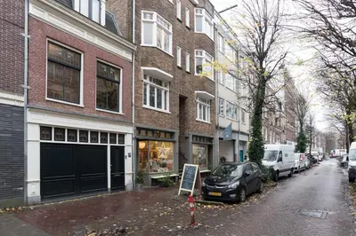 a brick building with a car parked on a street at B&B Felix in Amsterdam