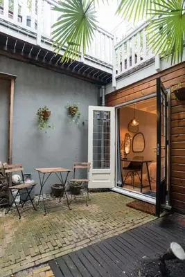 a patio with a table and chairs on a patio at B&B Felix in Amsterdam