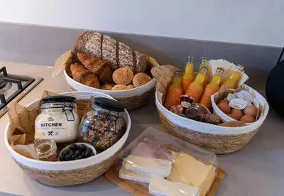three baskets filled with different types of bread and cheese at Hofje van Sint Jan in Gouda