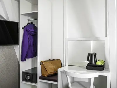 a room with a white table and a chair at ibis Styles Amsterdam Amstel in Amsterdam