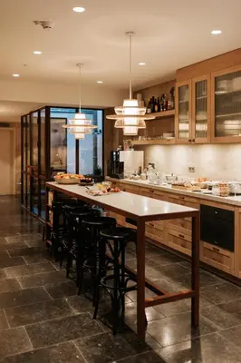 a large kitchen with a long table and chairs at The Times Hotel in Amsterdam