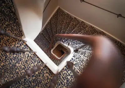 an overhead view of a spiral stair case at The Times Hotel in Amsterdam