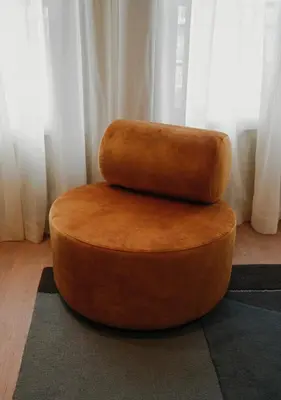 a brown ottoman with two pillows on top at The Times Hotel in Amsterdam
