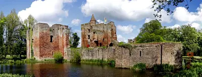 an old castle in the middle of a body of water at Hotel De Weyman in Santpoort-Noord