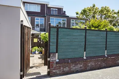 a wooden fence in front of a house at Het Krekeltje in Zandvoort