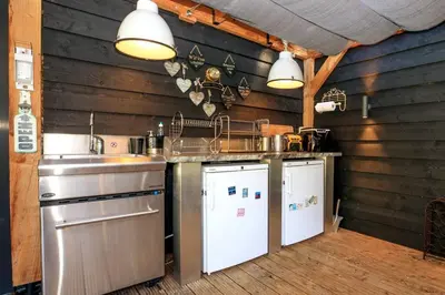 a kitchen with a sink and a dishwasher at Bohemian included boat supboards and pool 5 minutes by boat from parking to the bohemien in Loosdrecht