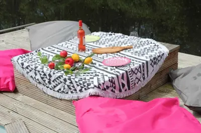 a table topped with a white and black at Bohemian included boat supboards and pool 5 minutes by boat from parking to the bohemien in Loosdrecht