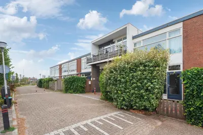 an empty street in front of a building at 't Schelpje with free parking in Zandvoort