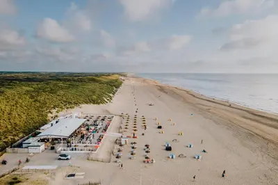 an overhead view of a beach with a crowd of people at 't Schelpje with free parking in Zandvoort