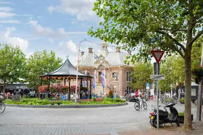 a building with a gazebo in the middle of a street at 't Schelpje with free parking in Zandvoort