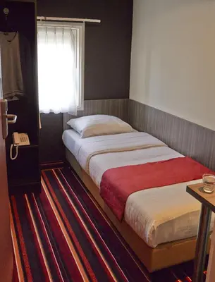 a bedroom with two beds and a window at Mozart Hotel in Amsterdam