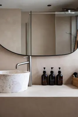 a bathroom with a sink and a mirror at Familiehuis aan zee met ruim dakterras in Zandvoort