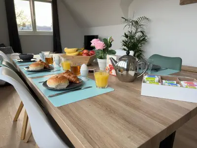 a table with croissants and glasses of orange juice at Duinroos vlakbij strand in Egmond aan Zee