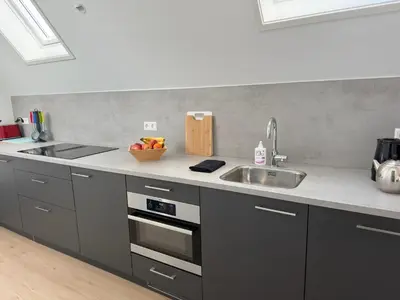 a kitchen with a sink and a counter top at Duinroos vlakbij strand in Egmond aan Zee