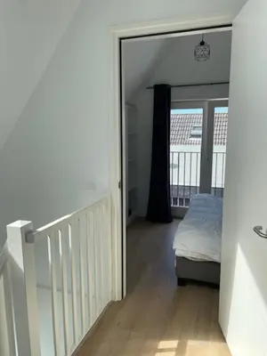 a bedroom with a mirror and a bed in it at Duinroos vlakbij strand in Egmond aan Zee