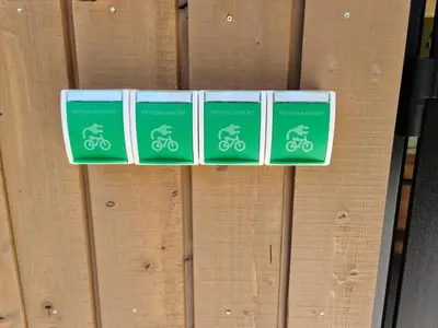 four green signs on a wooden wall at Bungalowpark Mooyeveld in Egmond-Binnen