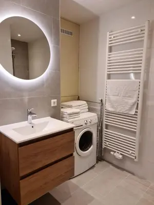 a bathroom with a washing machine and a sink at Bungalowpark Mooyeveld in Egmond-Binnen