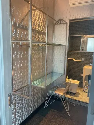 a glass shower in a bathroom with a tub at Diamond Capsule Hotel Amsterdam South in Amstelveen