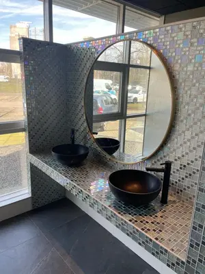 a bathroom with two sinks and a mirror at Diamond Capsule Hotel Amsterdam South in Amstelveen