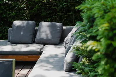 a couch with pillows sitting on a patio at Hotel Roemer Amsterdam in Amsterdam
