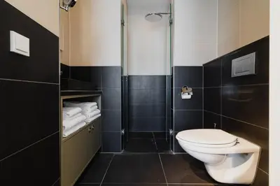 a bathroom with a toilet and a shower at Hotel Roemer Amsterdam in Amsterdam