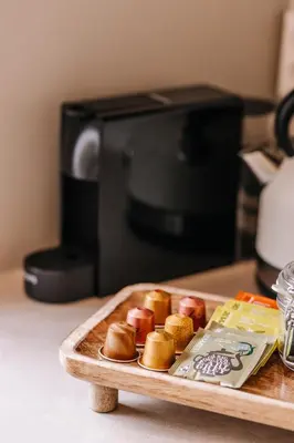 a tray of pastries on a table in front of a microwave at Casa la Vida Beach House in Zandvoort
