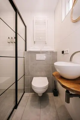 a bathroom with a white toilet and a sink at Casa la Vida Beach House in Zandvoort