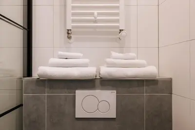 a pile of towels on a counter in a bathroom at Casa la Vida Beach House in Zandvoort