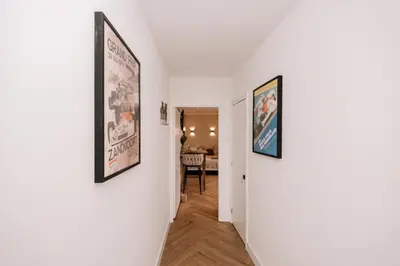 a hallway with two framed posters on the walls at Casa la Vida Beach House in Zandvoort