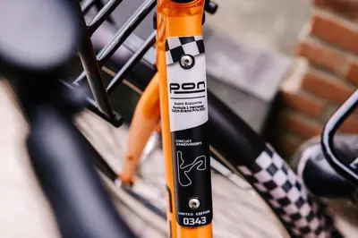 an orange and black bottle on the side of a bike at Casa la Vida Beach House in Zandvoort