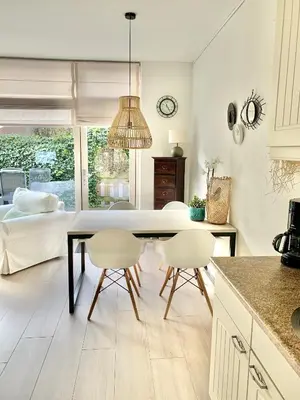 a kitchen and dining room with a table and chairs at Apartment Sunflower Zandvoort in Zandvoort