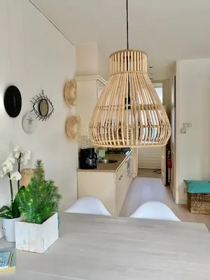 a kitchen with a table with a chandelier at Apartment Sunflower Zandvoort in Zandvoort