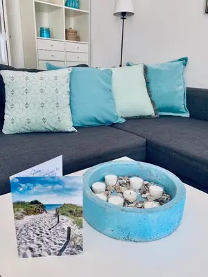 a living room with a couch and a bowl of shells at Apartment Sunflower Zandvoort in Zandvoort