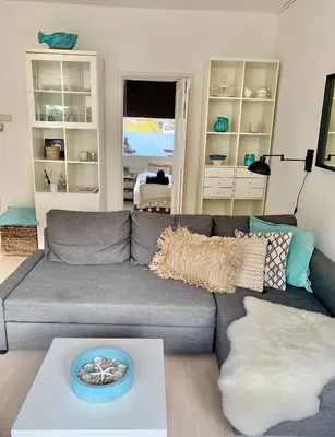 a living room with a gray couch and a table at Apartment Sunflower Zandvoort in Zandvoort