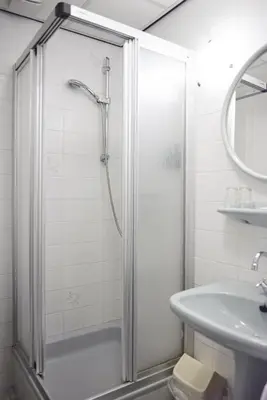 a bathroom with a shower and a sink at Hotel Restaurant de Jonge Heertjes in Aalsmeer