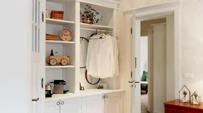 a room with a white shelf with a shirt on it at Hotel Station Amstelveen in Amstelveen