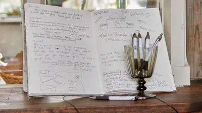 an open book on a table next to a cup of pens at Hotel Station Amstelveen in Amstelveen