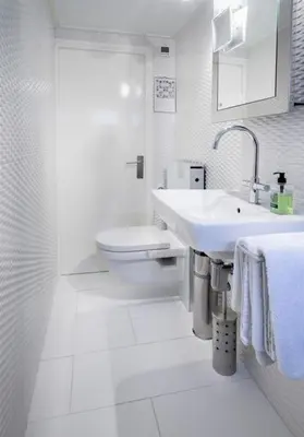 a white bathroom with a sink and a toilet at Houseboat Orpheus in Amsterdam