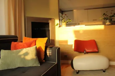 a living room with a couch and a chair at Houseboat Orpheus in Amsterdam