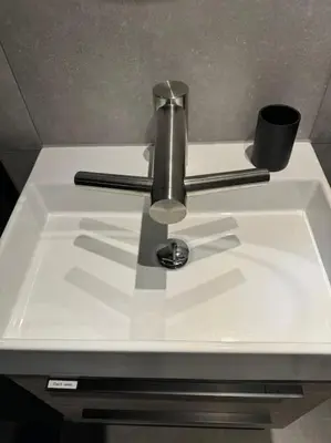 a sink with a faucet and a cup on it at Luxe woning Bubbles! Met airco en Parkeren op eigen grond in Castricum