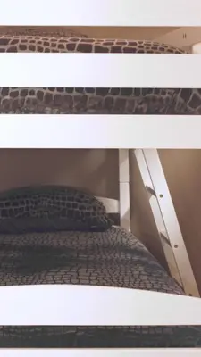 an upper shelf of a bunk bed with a pillow at Luxe woning Bubbles! Met airco en Parkeren op eigen grond in Castricum