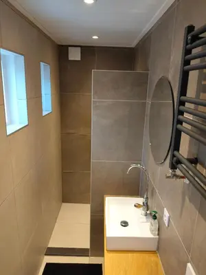 a bathroom with a sink and a mirror at Knusse vakantiewoning in Camperduin in Schoorl