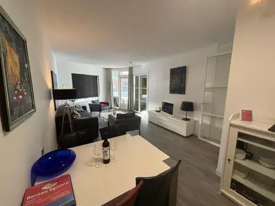 a living room with a table and a living room at Sterflat 83 in Egmond aan Zee
