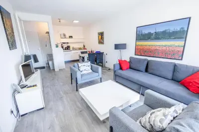 a living room with a couch and a table at Sterflat 83 in Egmond aan Zee