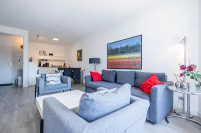 a living room with a couch and two chairs at Sterflat 83 in Egmond aan Zee