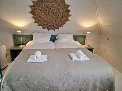 a bedroom with two towels on a bed at Hotel Liberte in Schoorl