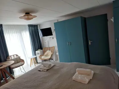 a bedroom with a bed with two towels on it at Hotel Liberte in Schoorl