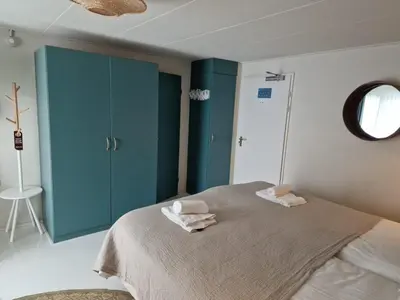 a bedroom with a bed with two towels on it at Hotel Liberte in Schoorl