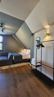 a bedroom with a bed and a table in a room at Guest Room Utrecht in Utrecht