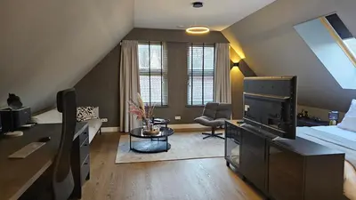 a bedroom with a bed and a living room at Guest Room Utrecht in Utrecht